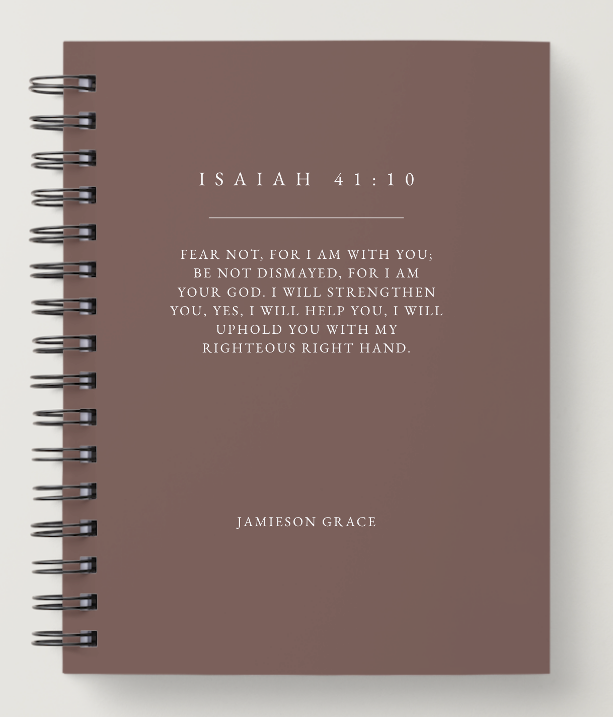 Notebook with Isaiah 41:10 quote on a brown background
